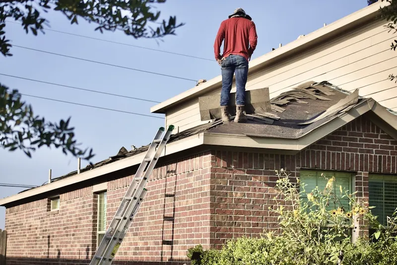 Professional roofer working on a residential roof in Beaumont